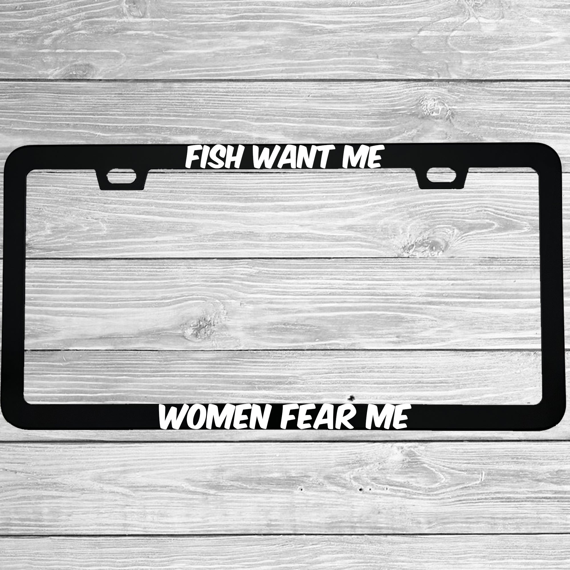 Close-up of "Fish Want Me, Women Fear Me" license plate frame showing fade-proof print quality