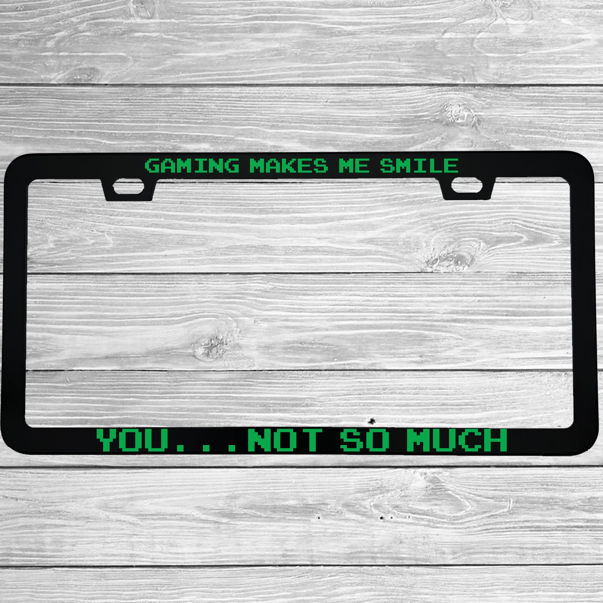 Close-up of "Gaming Makes Me Smile, You Not So Much" license plate frame showing fade-proof print quality