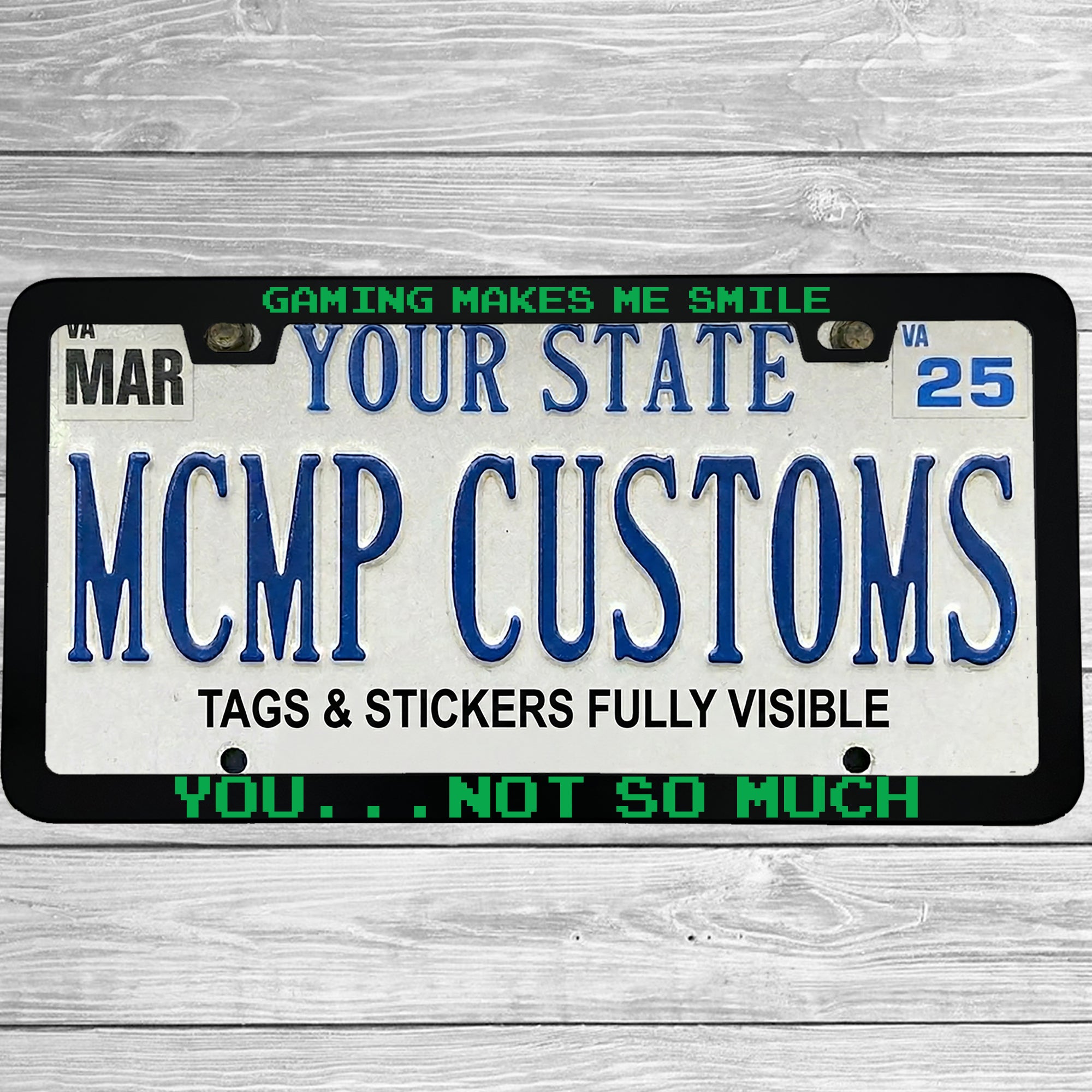 "Gaming Makes Me Smile, You Not So Much" license plate frame shown on vehicle — lifestyle photo