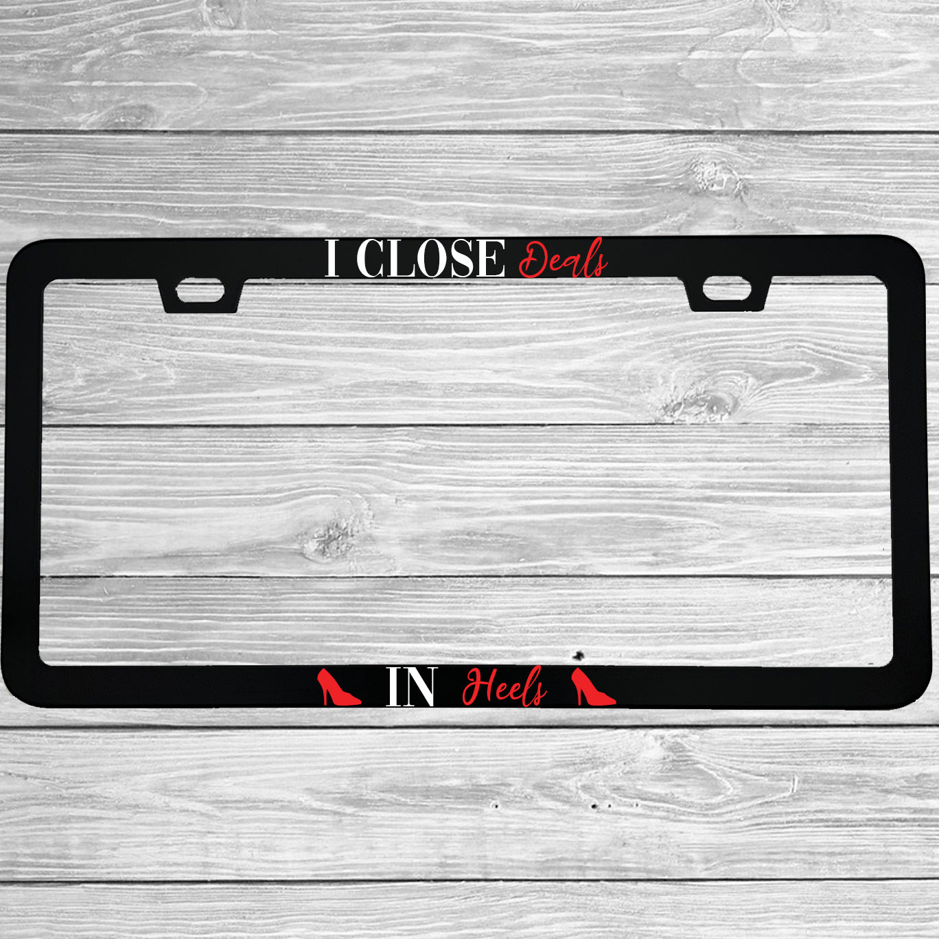 Close-up of "I Close Deals In Heels" license plate frame showing fade-proof print quality