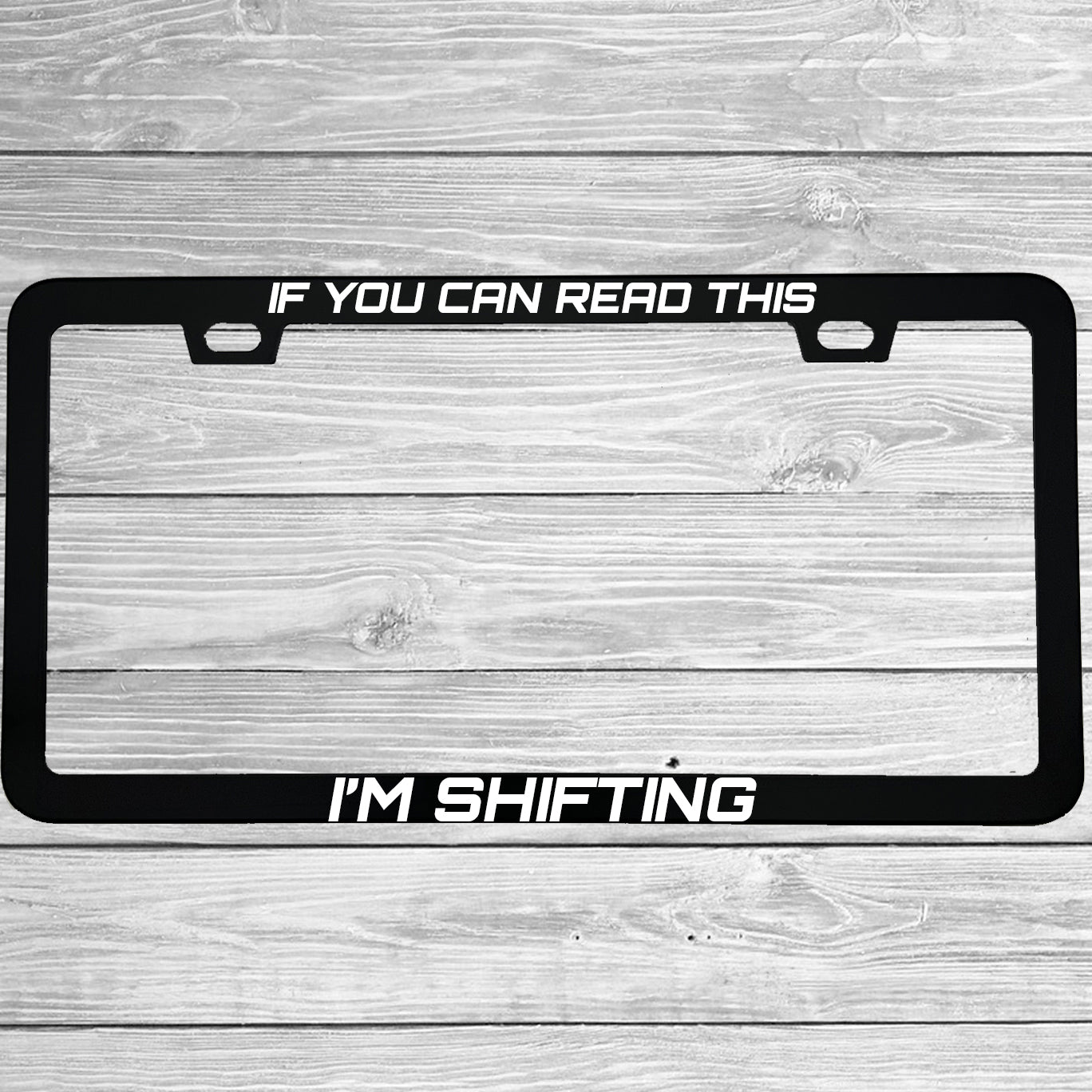 Close-up of "If You Can Read This I'm Shifting" license plate frame showing fade-proof print quality