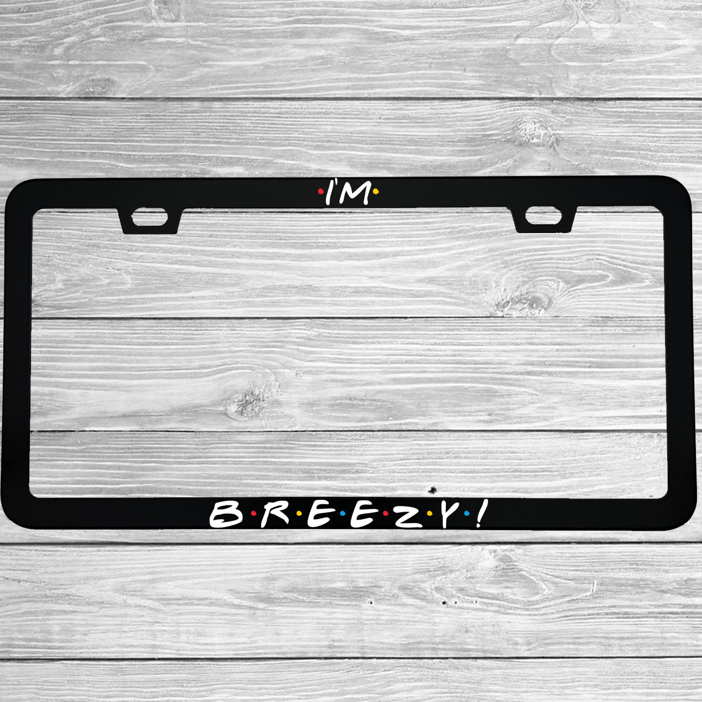 Close-up of "I'm Breezy" license plate frame showing fade-proof print quality