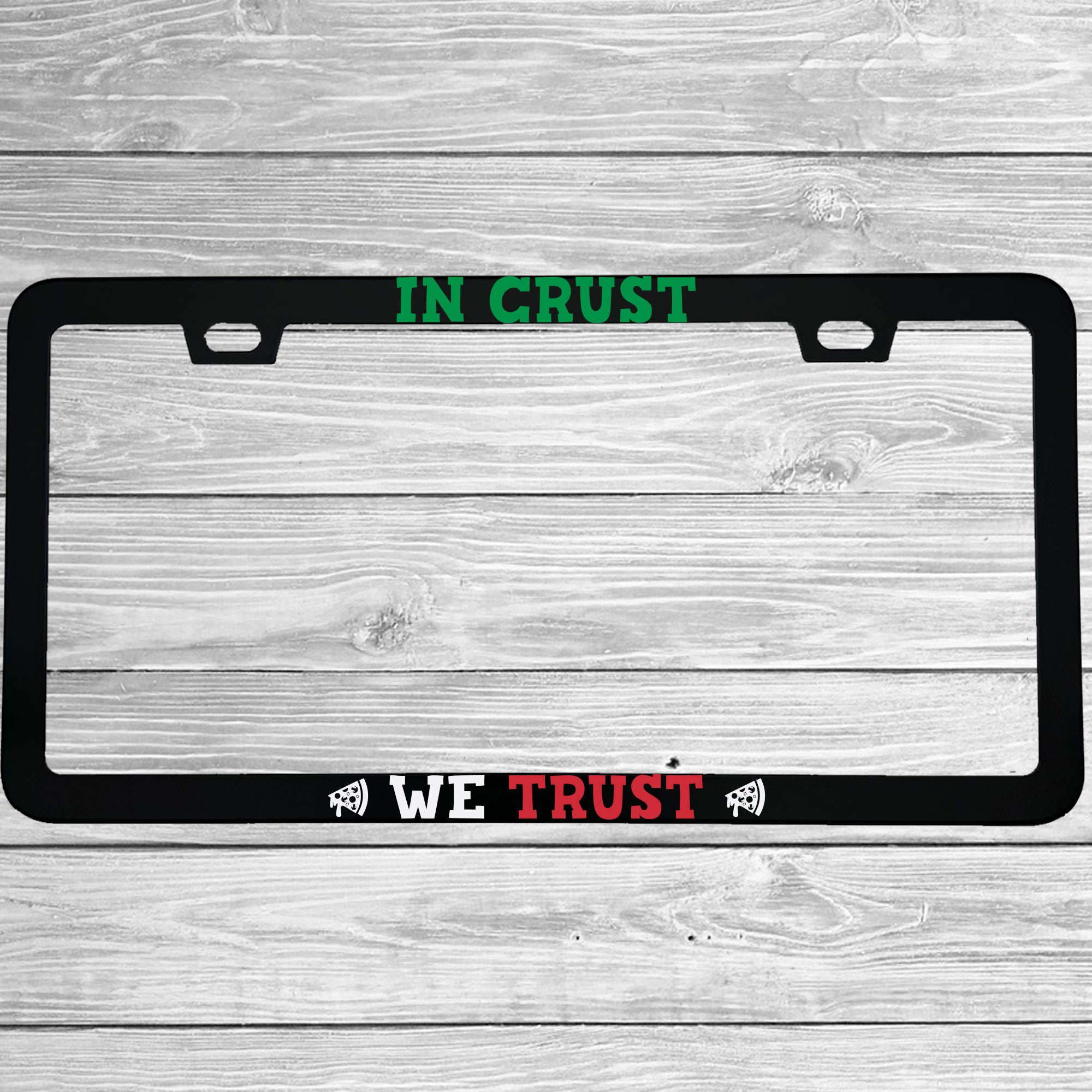 Close-up of "In Crust We Trust" license plate frame showing fade-proof print quality