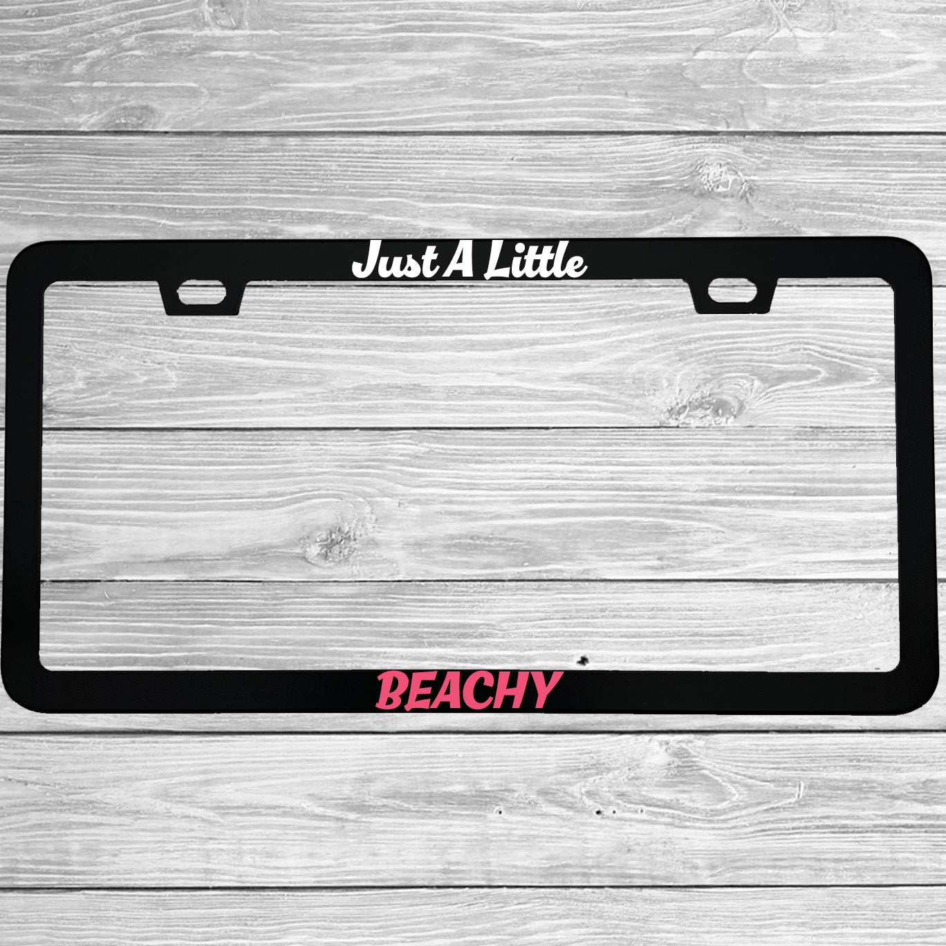 Close-up of "Just A Little Beachy" license plate frame showing fade-proof print quality