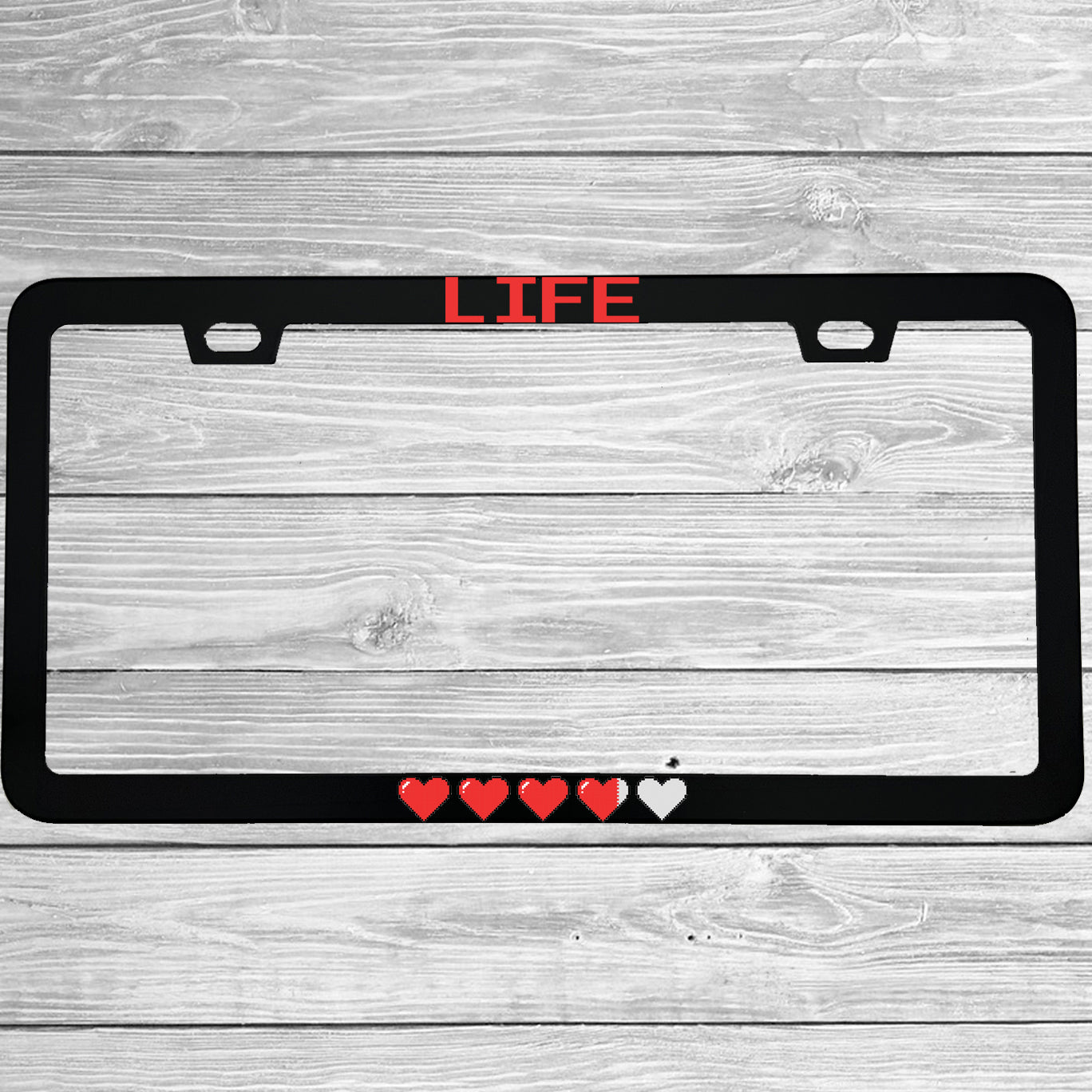 Close-up of "Life Pixel Hearts" license plate frame showing fade-proof print quality