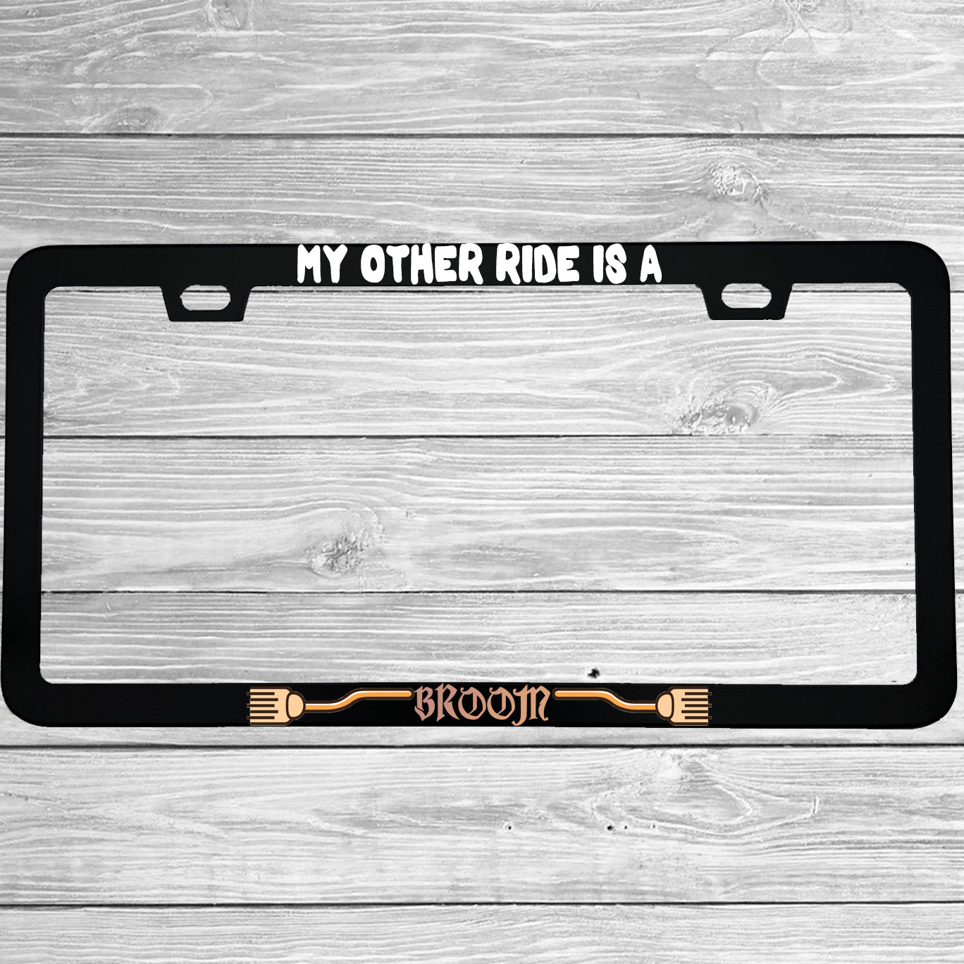 Close-up of "My Other Ride Is A Broom" license plate frame showing fade-proof print quality
