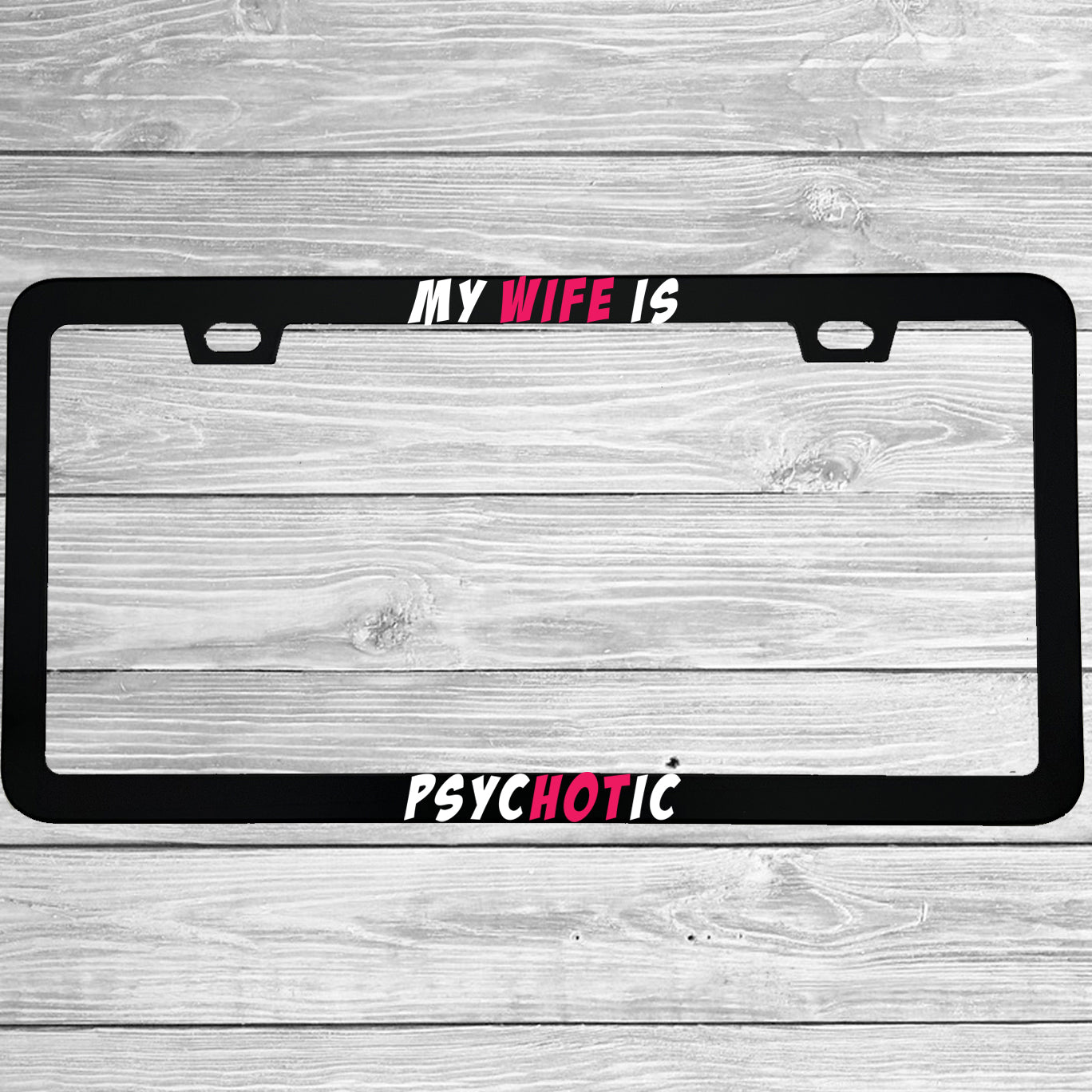 Close-up of "My Wife Is Psychotic" license plate frame showing fade-proof print quality