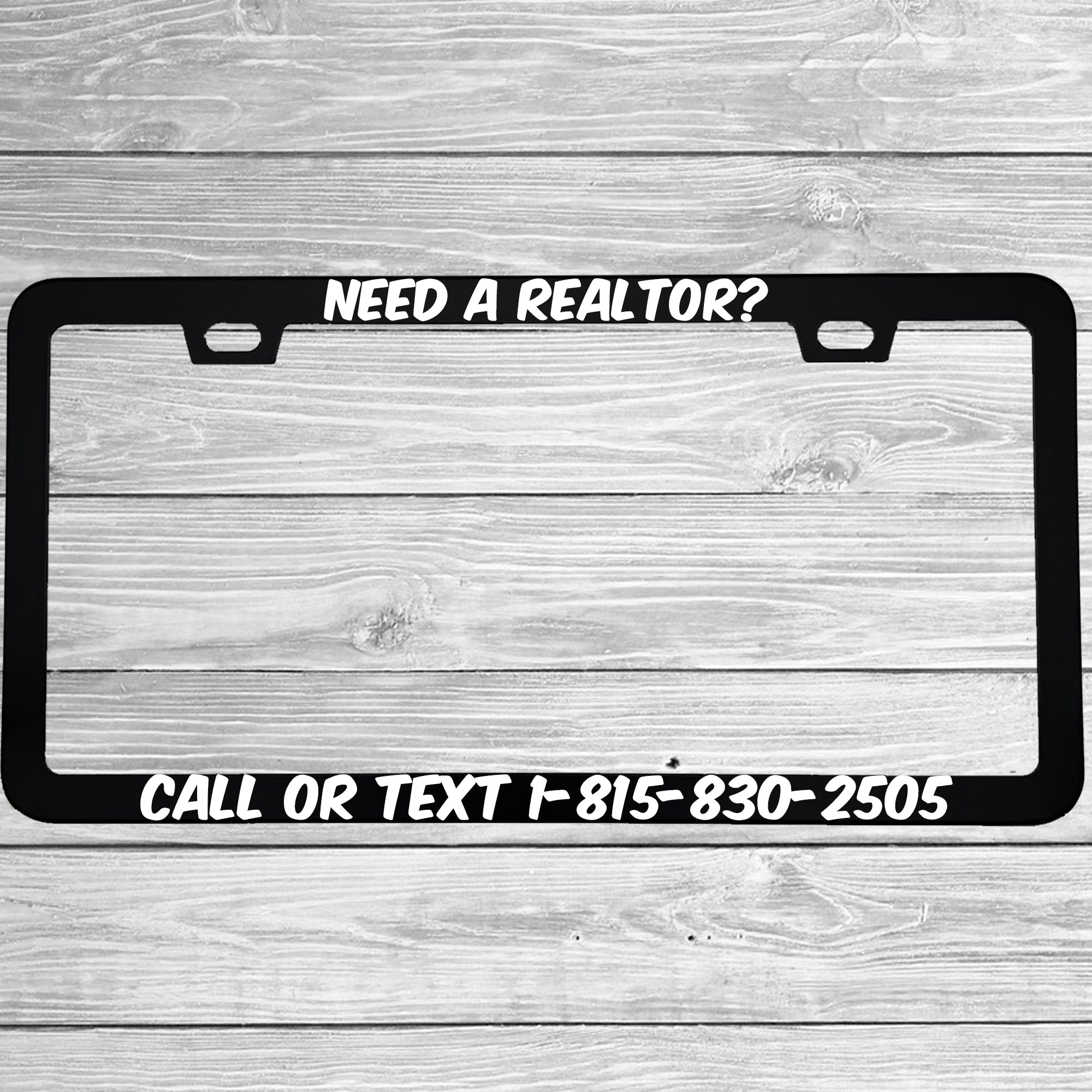 Close-up of "Need A Realtor?" license plate frame showing fade-proof print quality