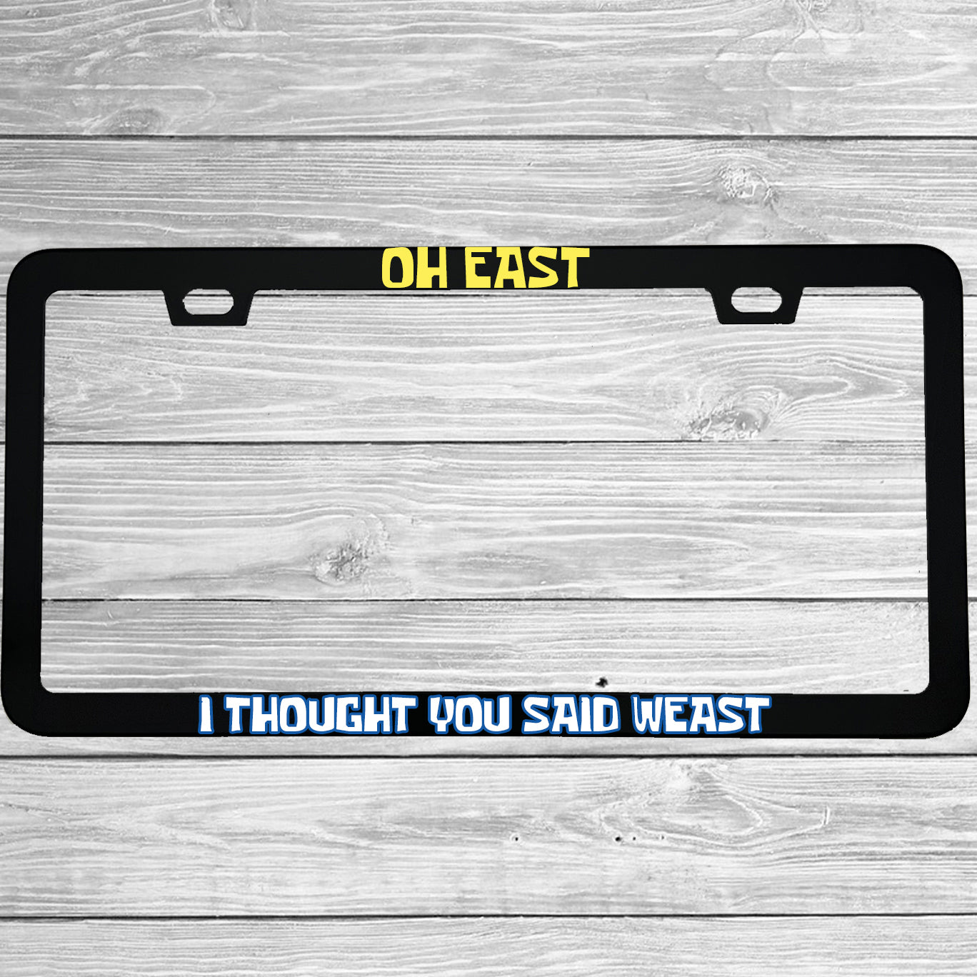Close-up of "Oh East I Thought You Said Weast" license plate frame showing fade-proof print quality