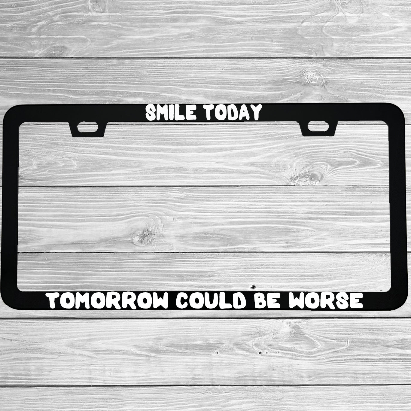 Close-up of "Smile Today Tomorrow Could Be Worse" license plate frame showing fade-proof print quality