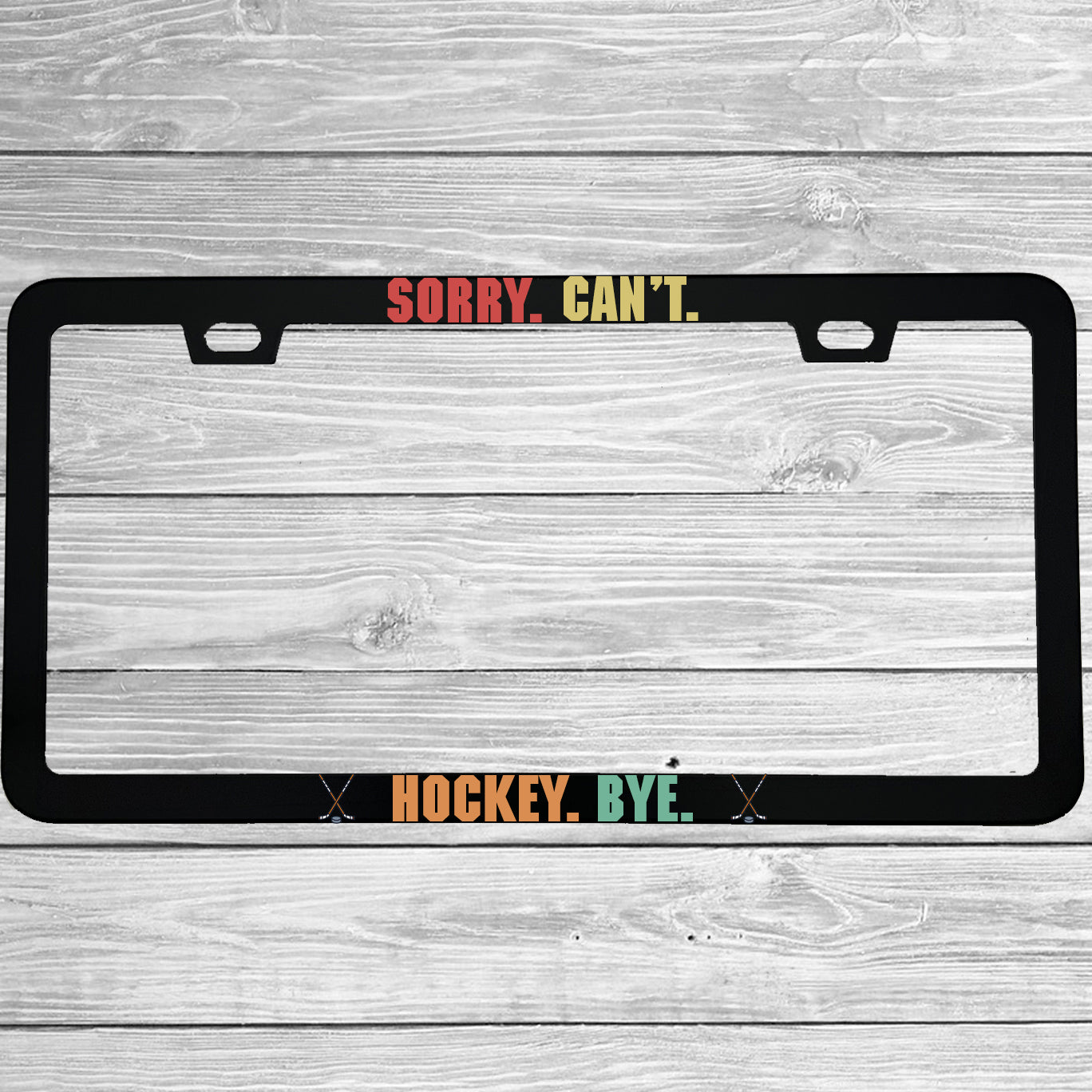 Close-up of "Sorry Cant Hockey Bye" license plate frame showing fade-proof print quality