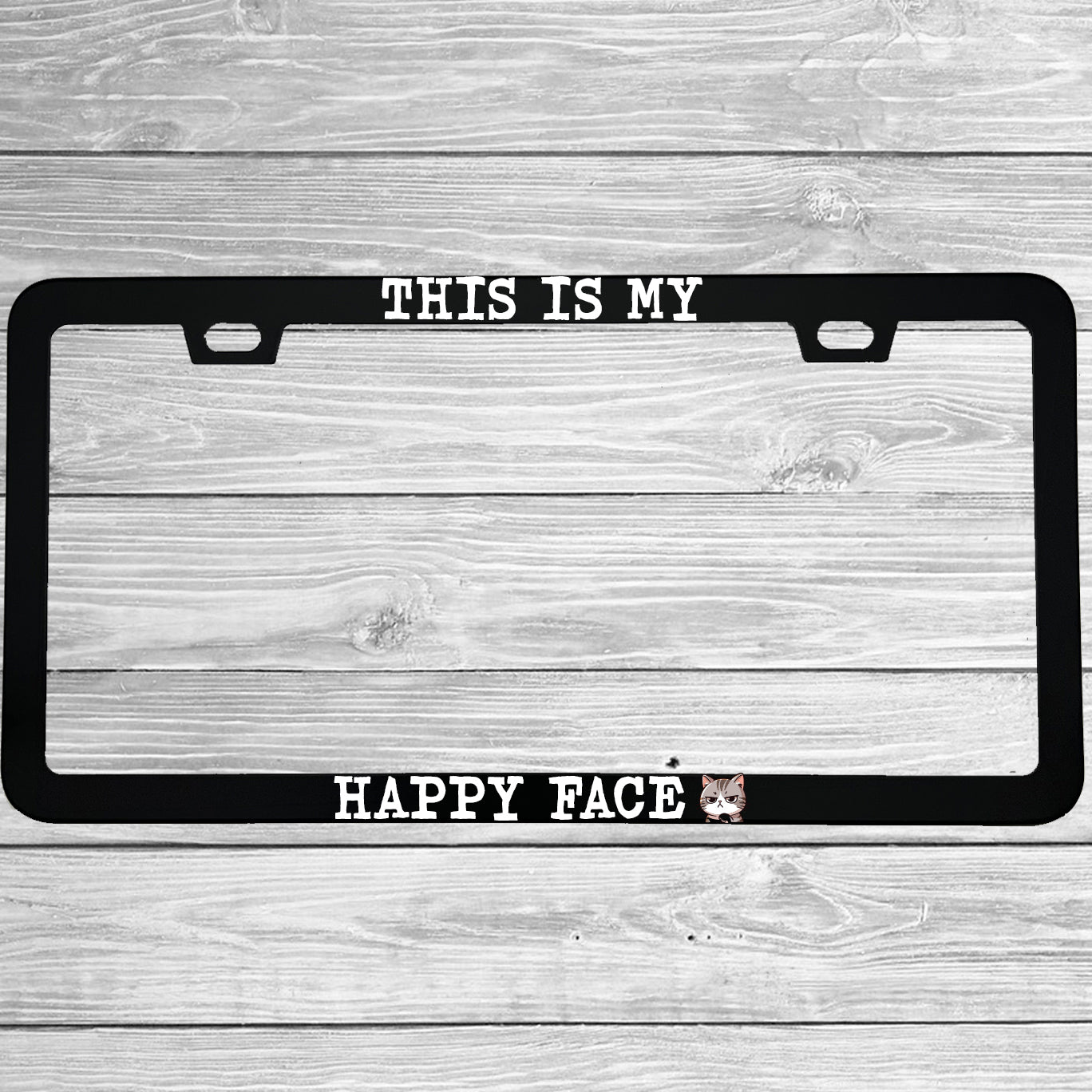 Close-up of "This Is My Happy Face" license plate frame showing fade-proof print quality