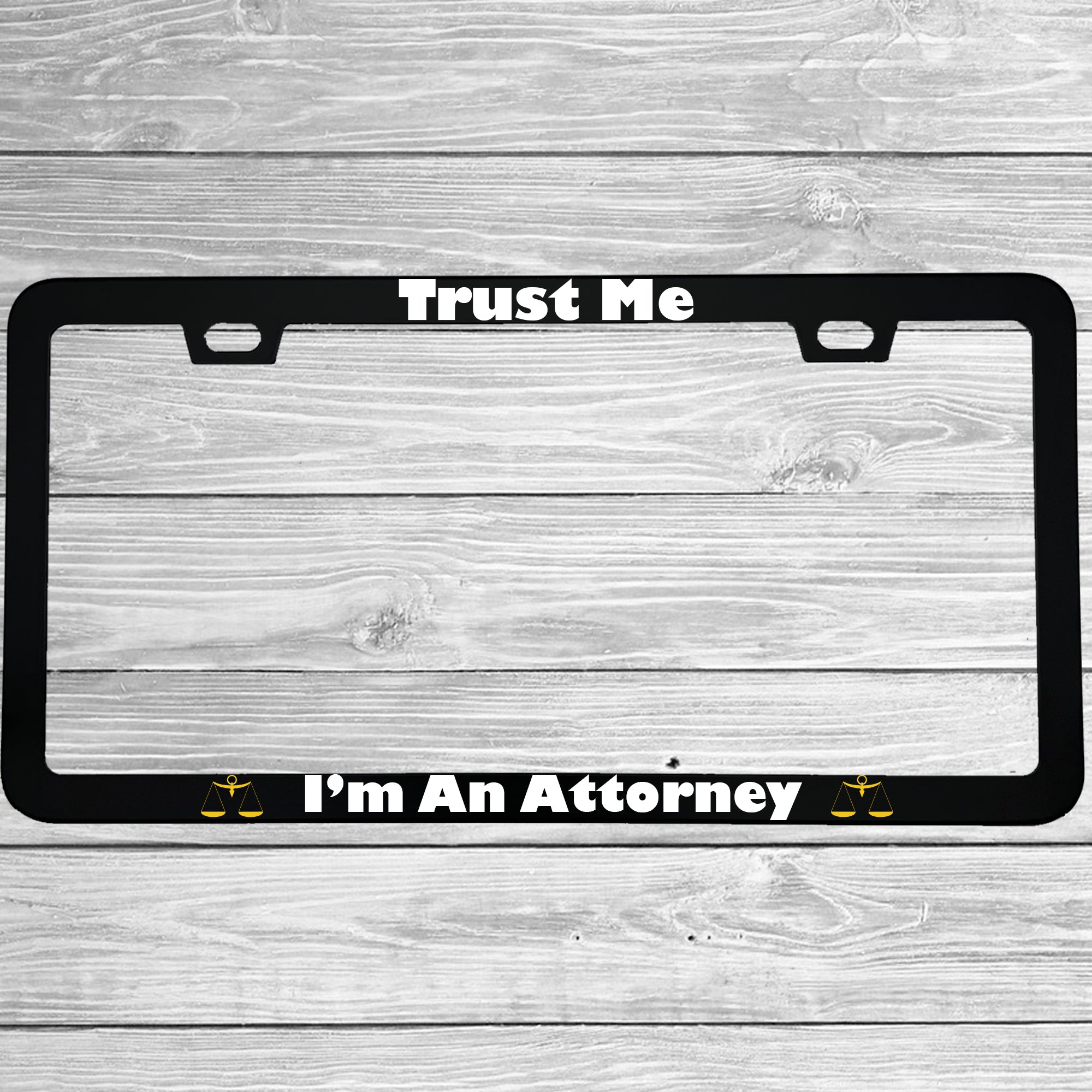 Close-up of "Trust Me I'm An Attorney" license plate frame showing fade-proof print quality